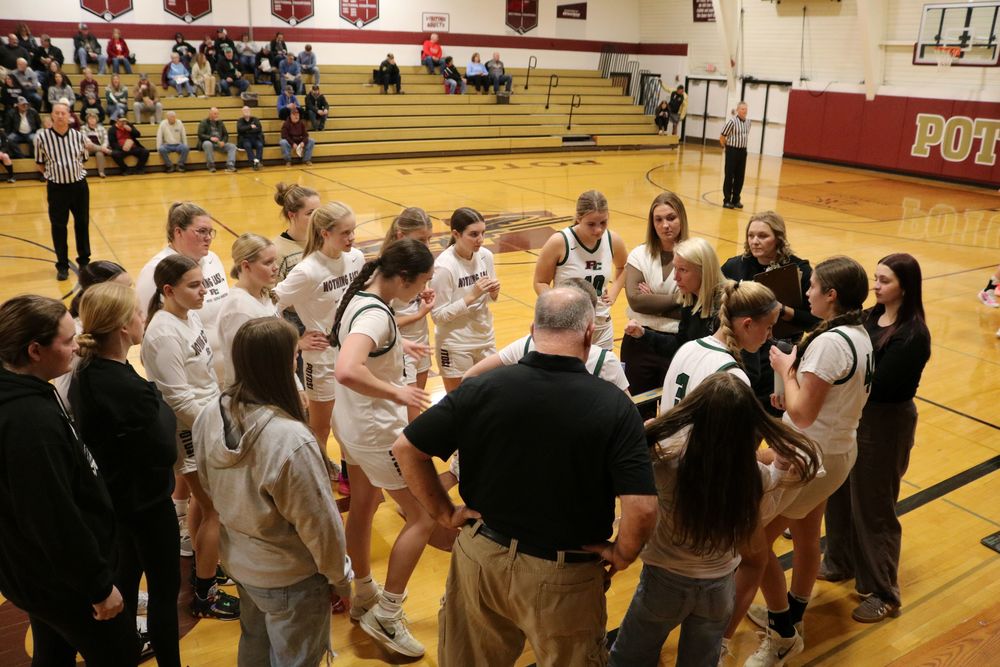 Girls basketball team huddles during timeout