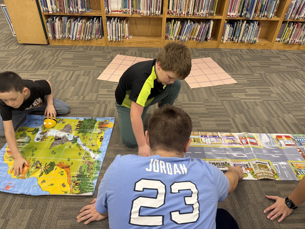 HS students using Beebots with ES students to learn how to code