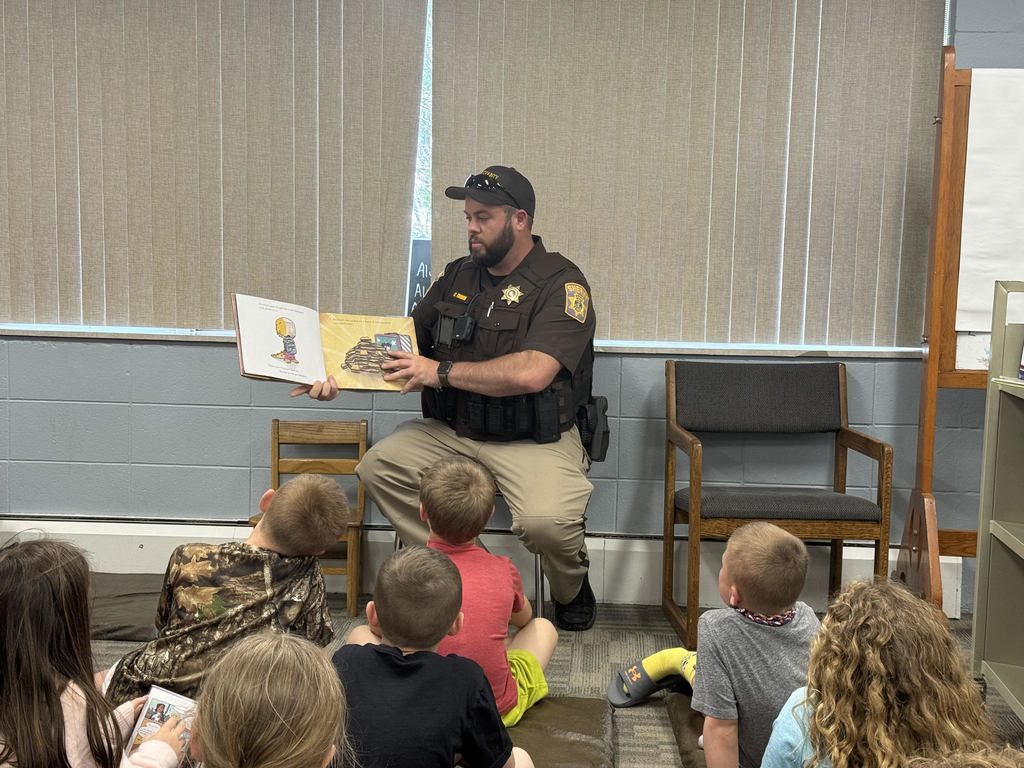 Officer Cody reads in the library