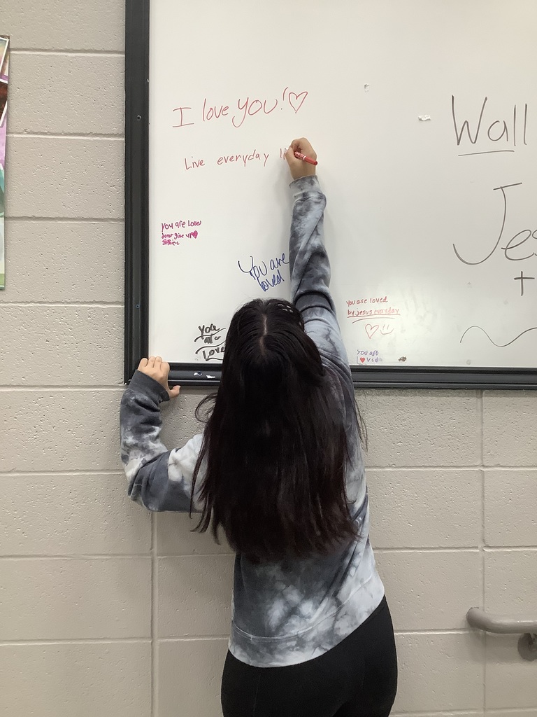 Image of student writing on Hope Wall