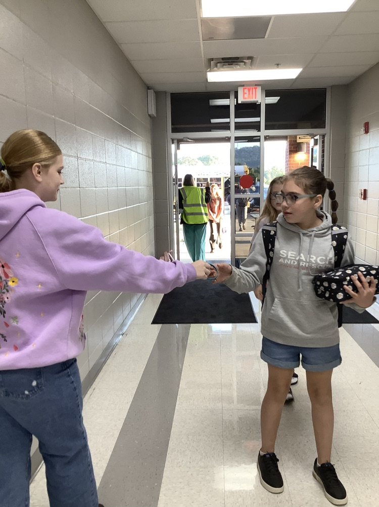 image of student handing out bracelets