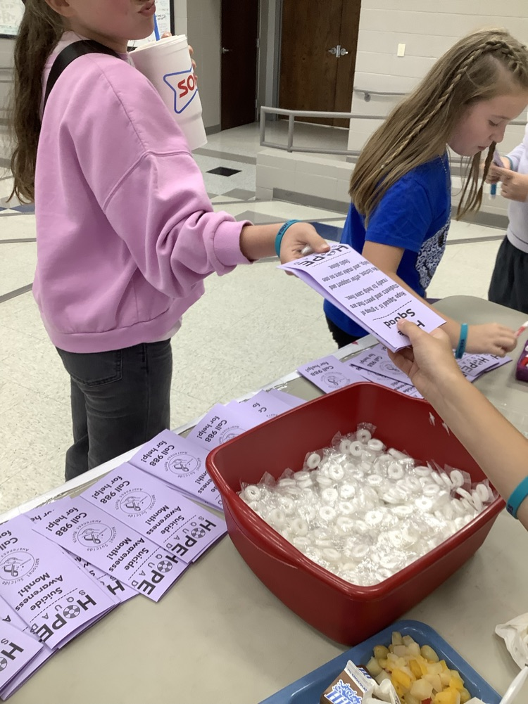 image of student handing out papers