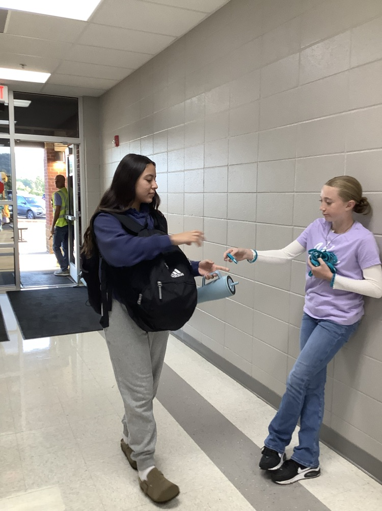 image of student handing out bracelets