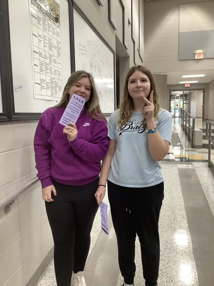 image of student handing out papers