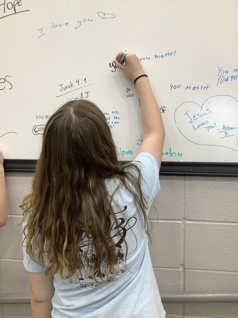 Image of student writing on Hope Wall