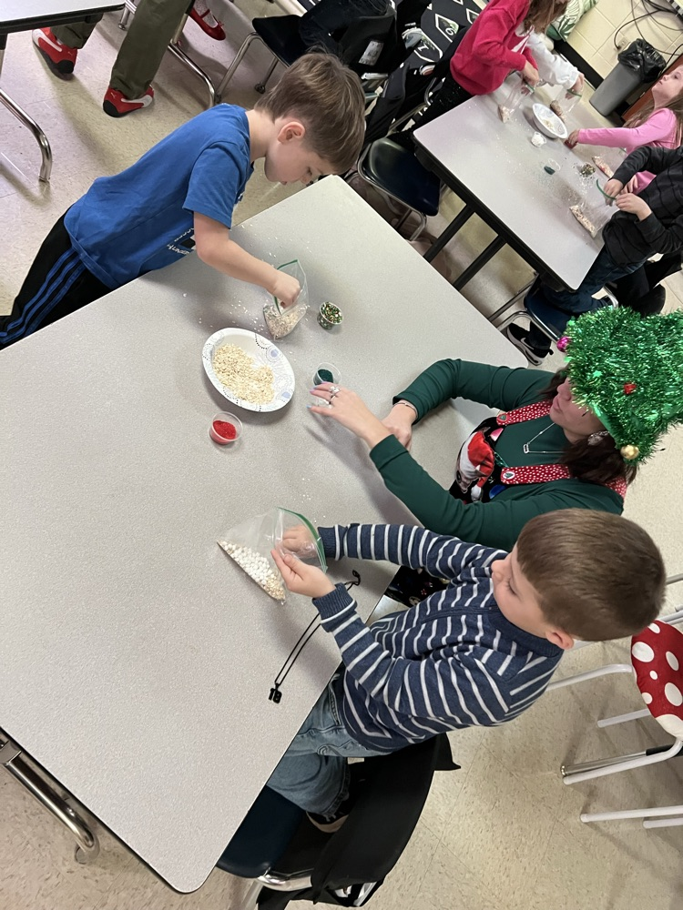 PES students and Tech student making reindeer food