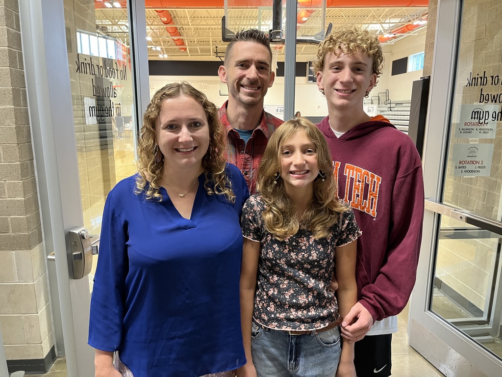 Two adults and two children  pose for a photo.