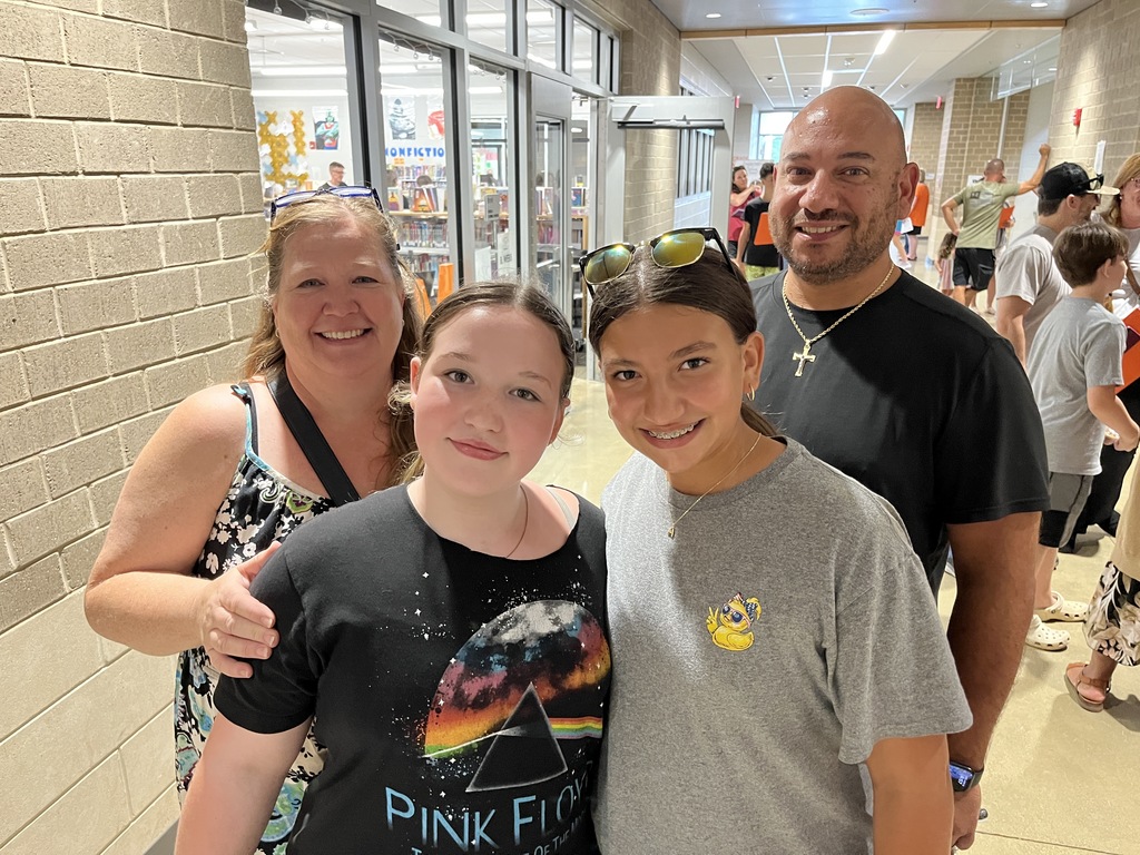 Two adults and two children  pose for a photo.
