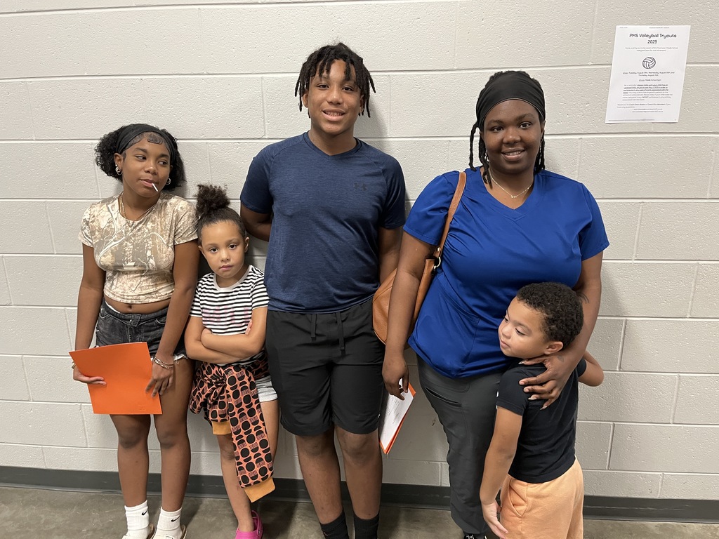 An adult and four children pose for a photo.