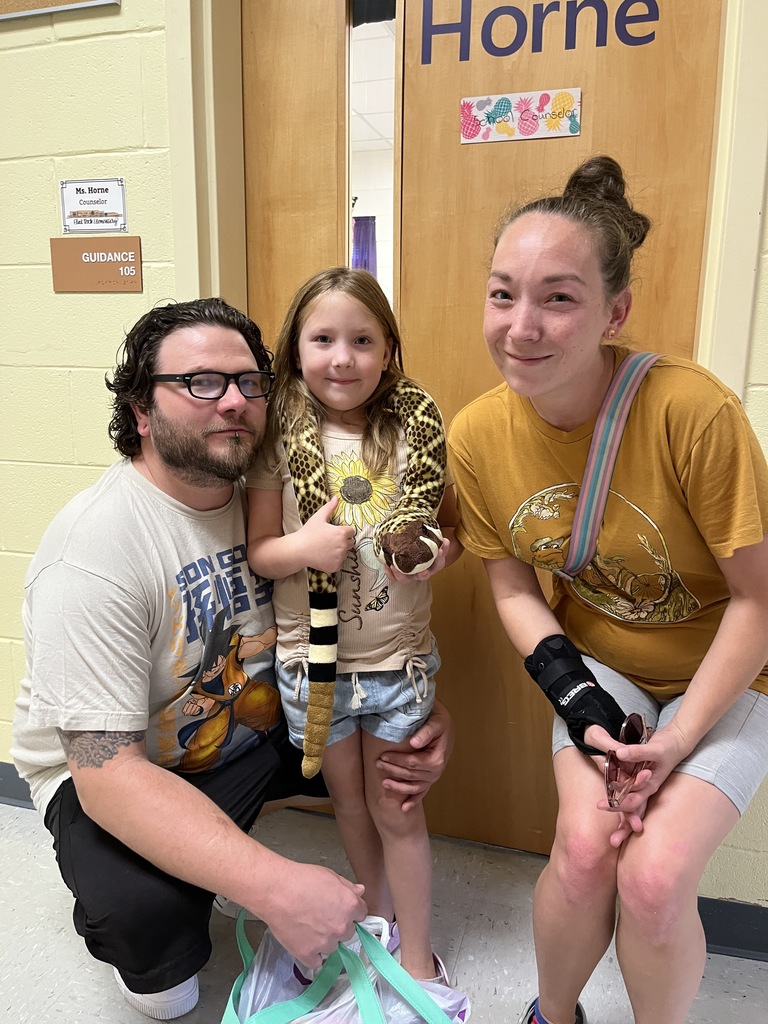 Two adults and a child pose for a photo. 
