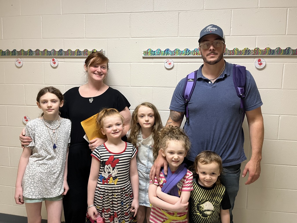 Two adults and five children pose for a photo. 