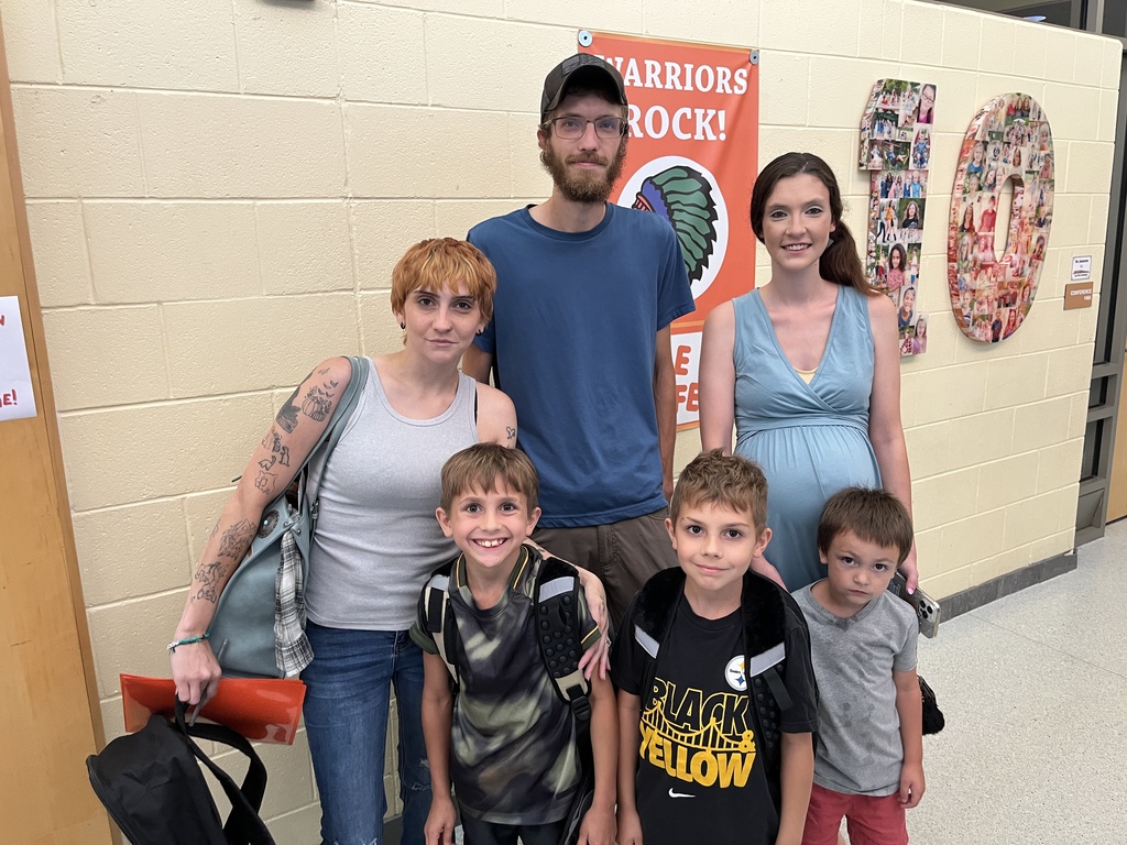 Three adults and three children pose for a photo. 