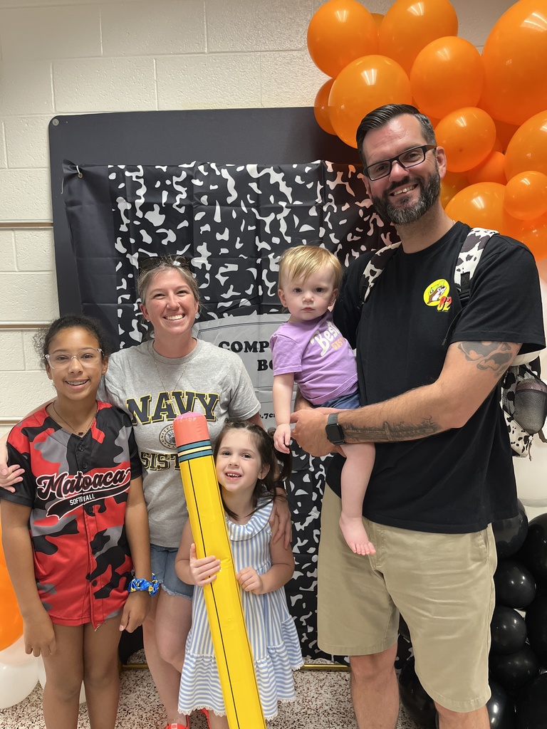 Two adults and three children  pose for a photo. 