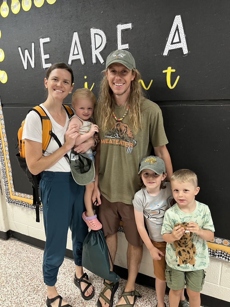 Two adults and three children  pose for a photo. 