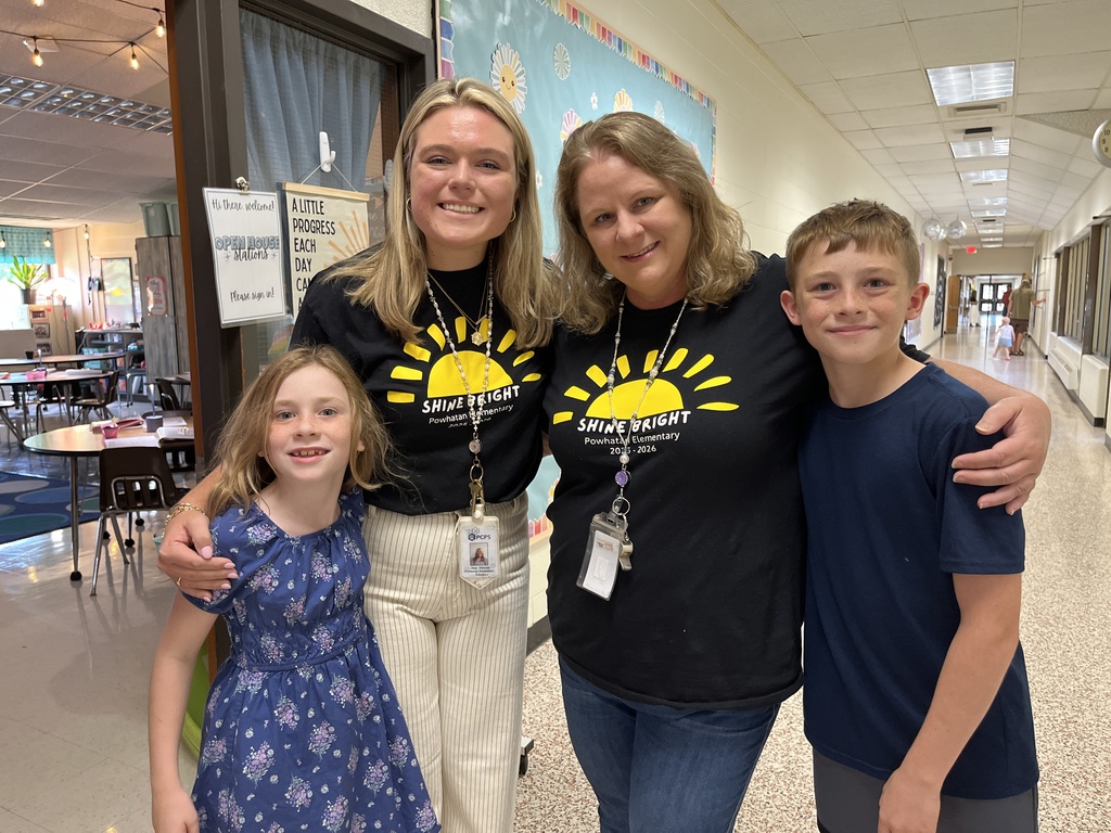 Two adults and two children  pose for a photo. 