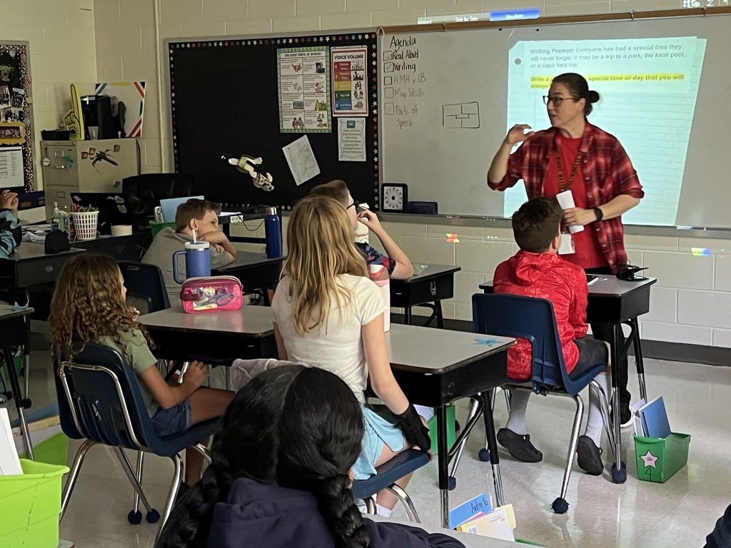 A teacher gives students instructions for their first writing prompt exercise of the school year. 