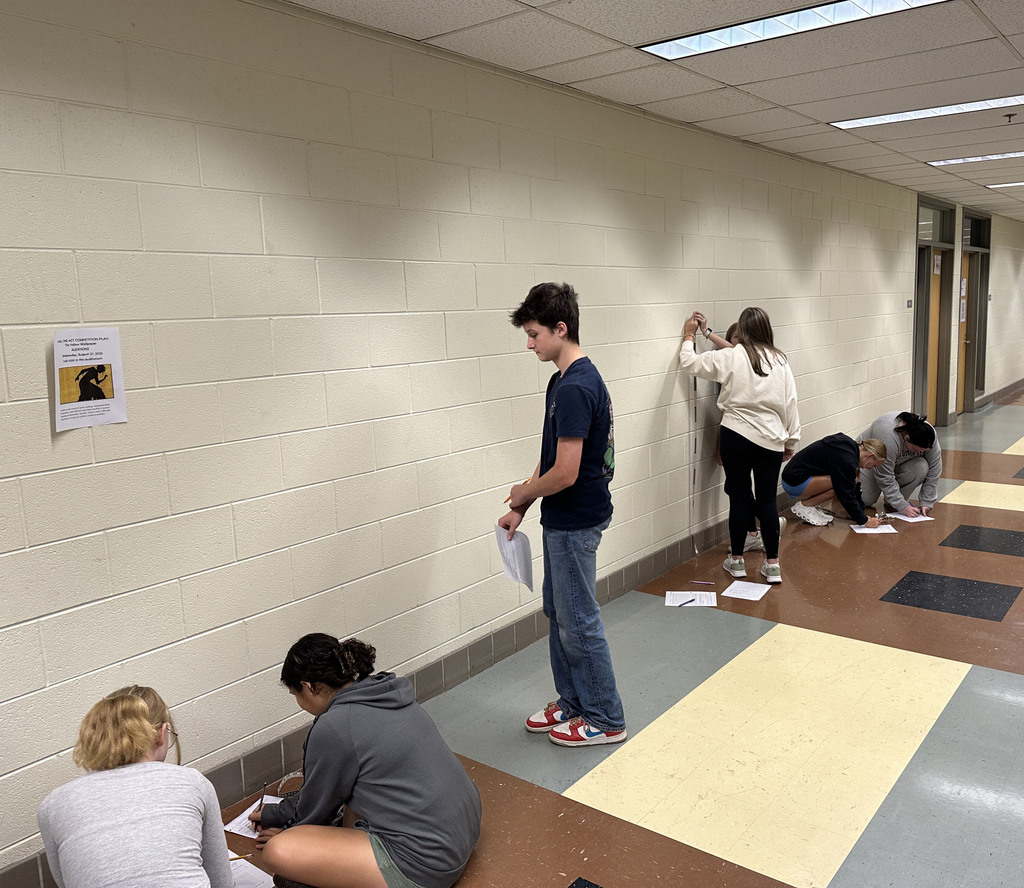 Algebra 1 students complete an activity on measuring height and handspan.