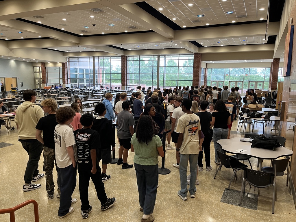 Students line up to receive their Chromebooks. 