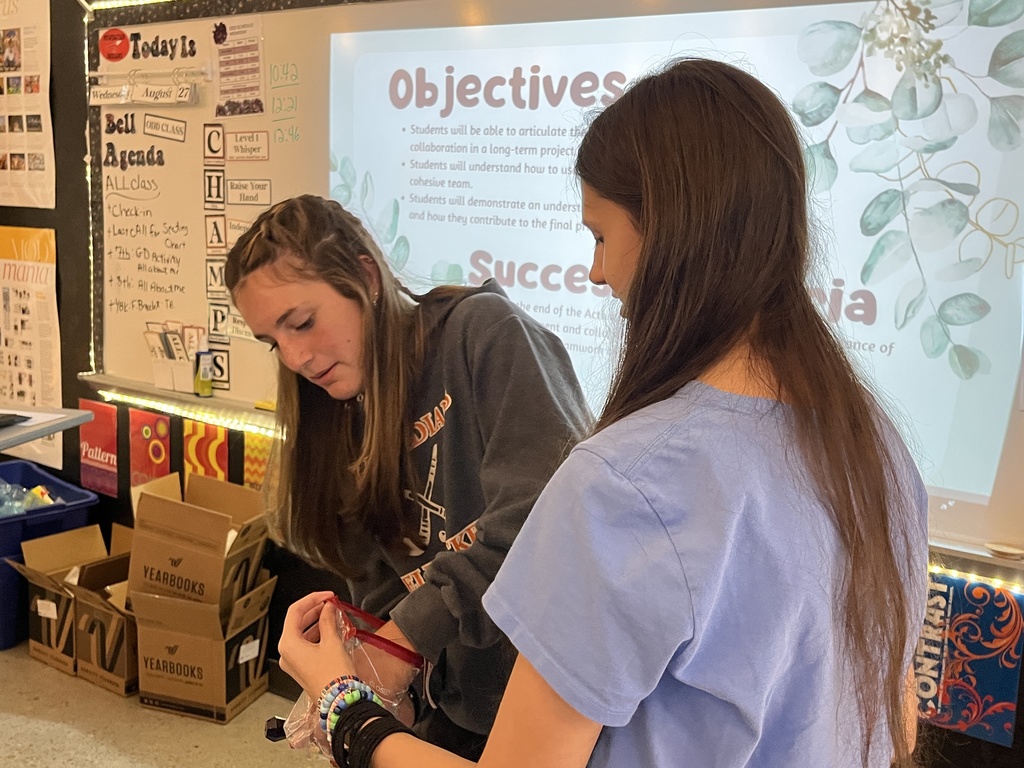 Students take bracelets out of a bag. 