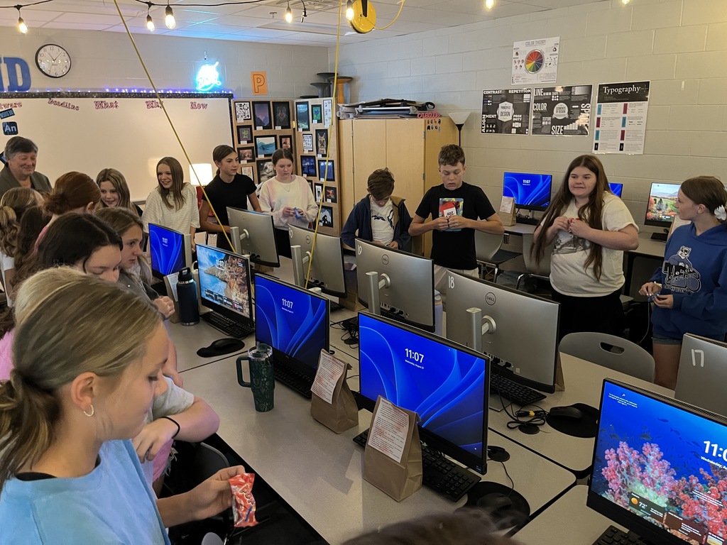 Students open goodie bags during a yearbook commitment ceremony. 