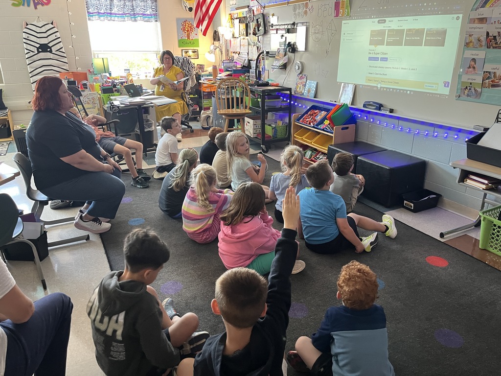 A teacher reviews vocabulary with a group of students. 