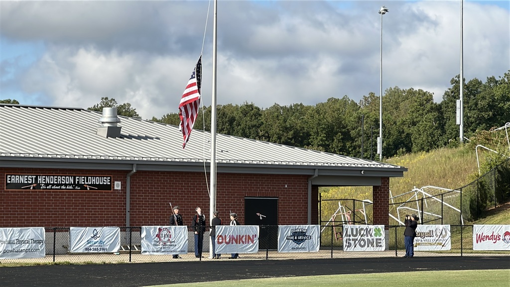 A JROTC cadet battalion conducts a 9/11 ceremony on a football field. 