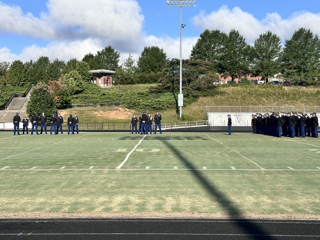 A JROTC cadet battalion conducts a 9/11 ceremony on a football field. 
