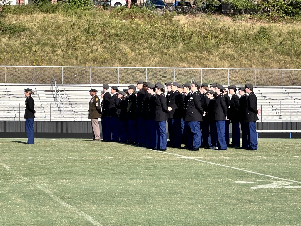 A JROTC cadet battalion conducts a 9/11 ceremony on a football field. 