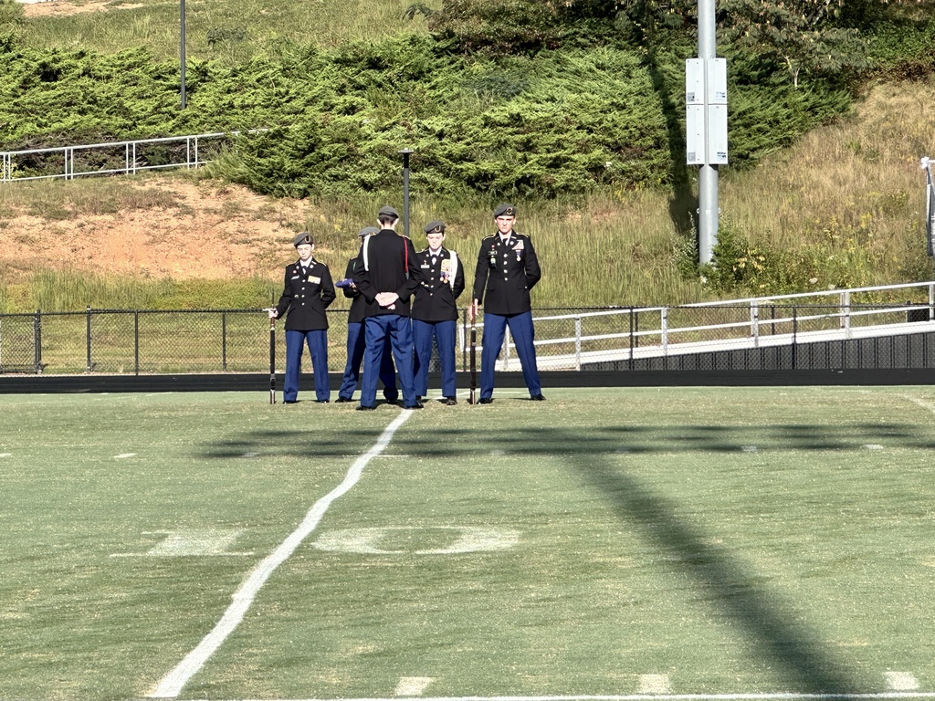 A JROTC cadet battalion conducts a 9/11 ceremony on a football field. 