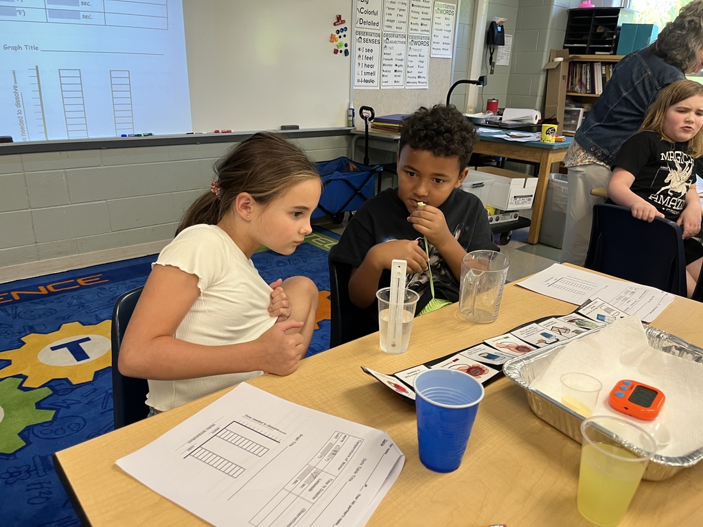 Students conduct a science experiment using lemonade.
