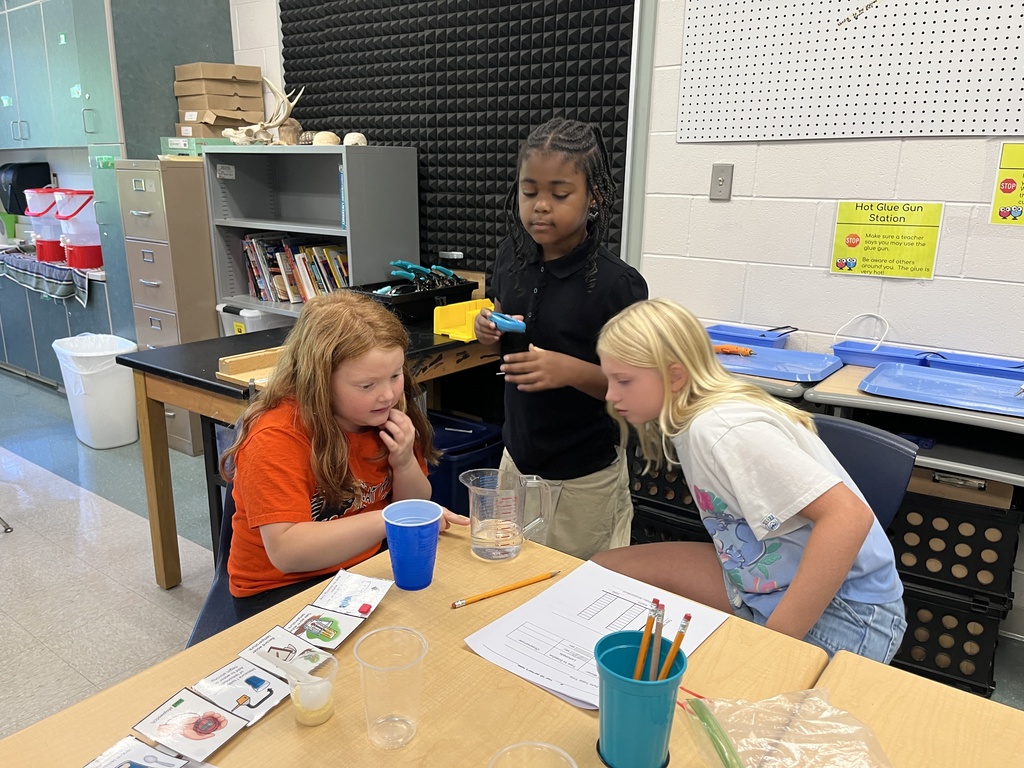 Students conduct a science experiment using lemonade.