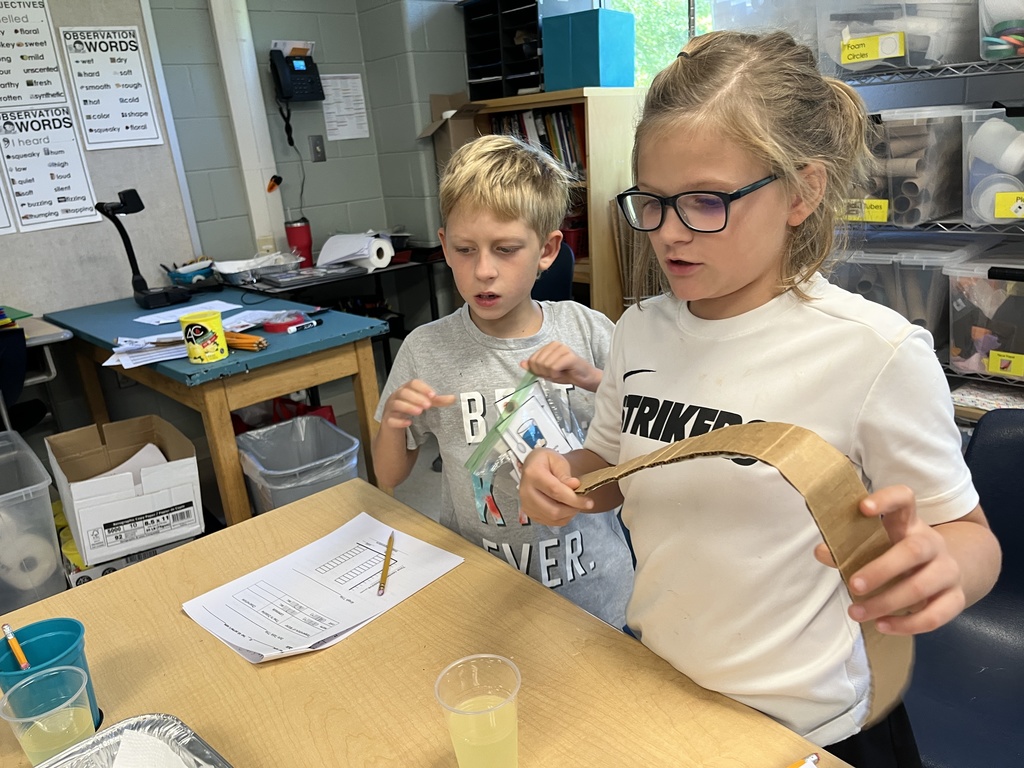 Students conduct a science experiment using lemonade.