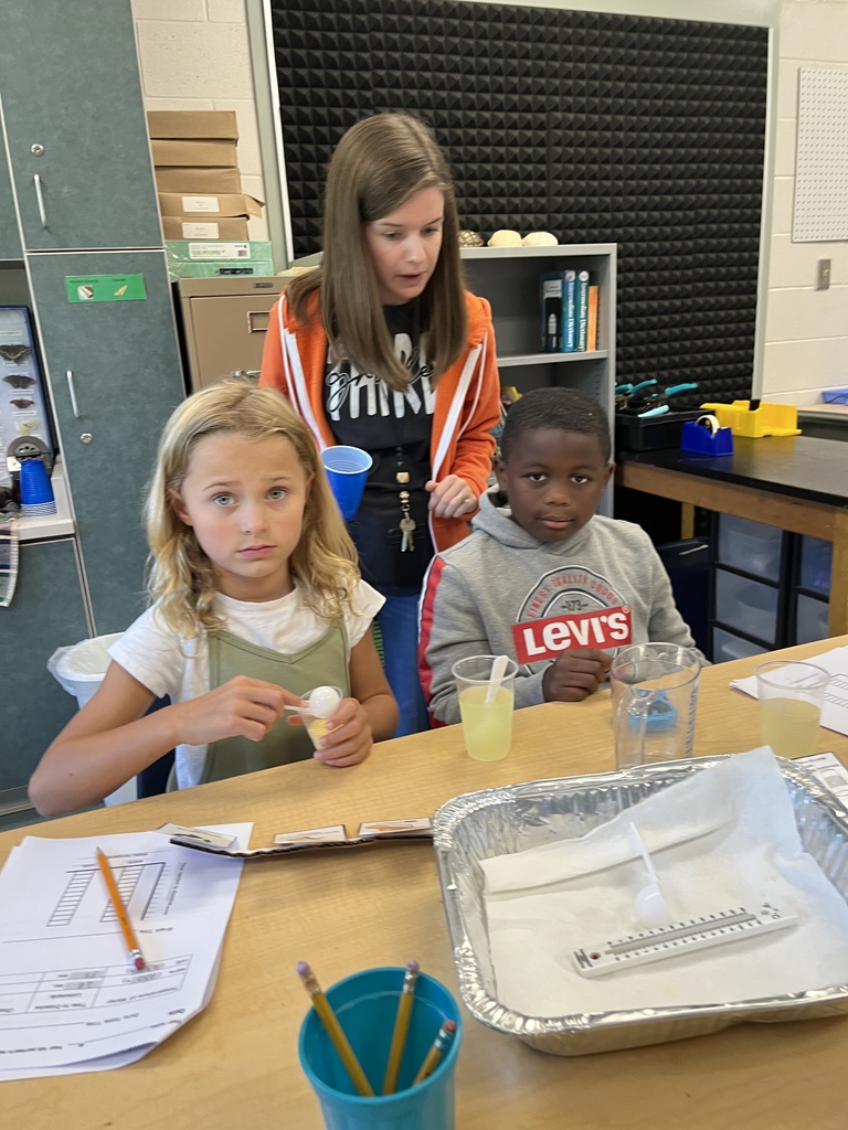 Students conduct a science experiment using lemonade.