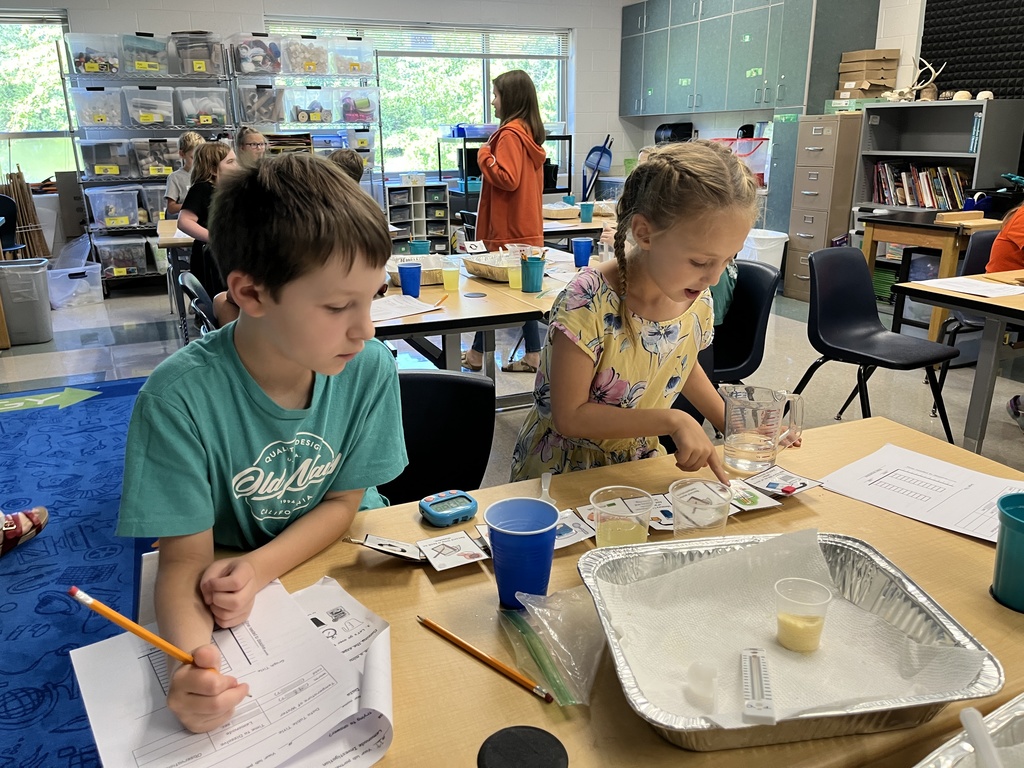 Students conduct a science experiment using lemonade.