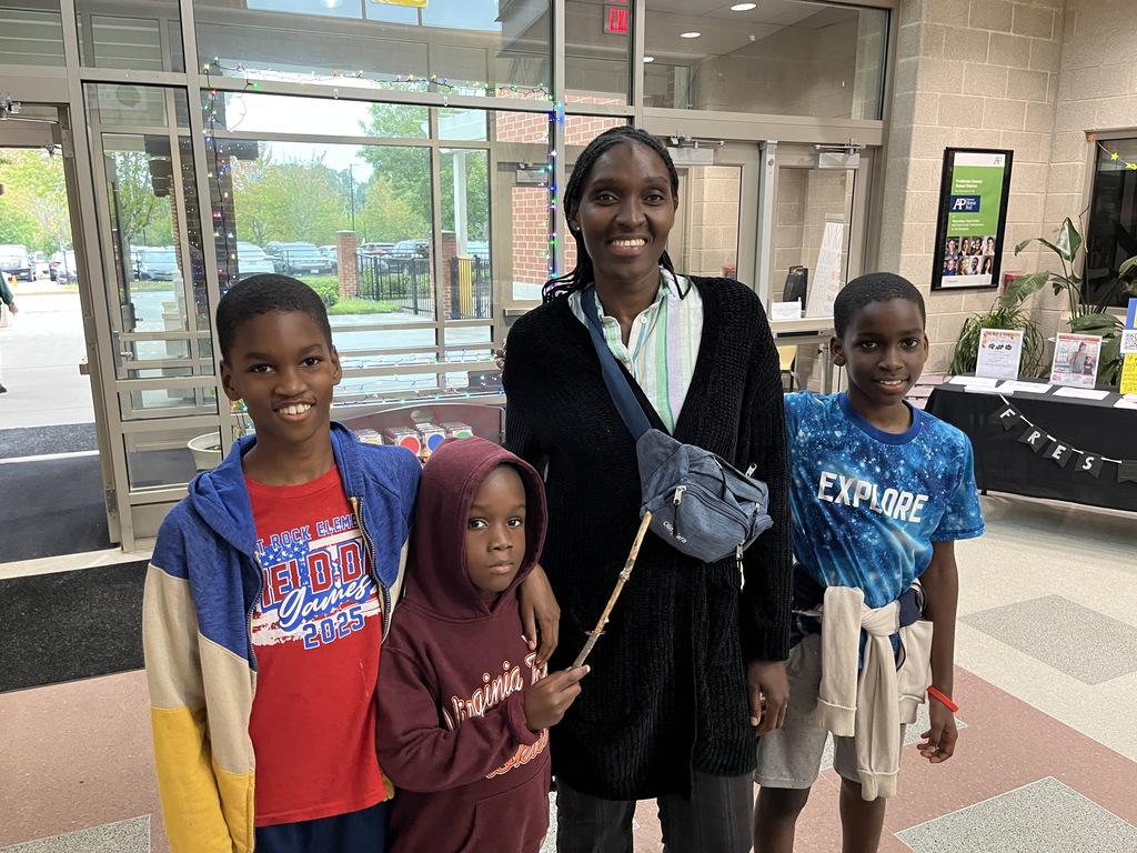 An adult and three children pose for a photo.