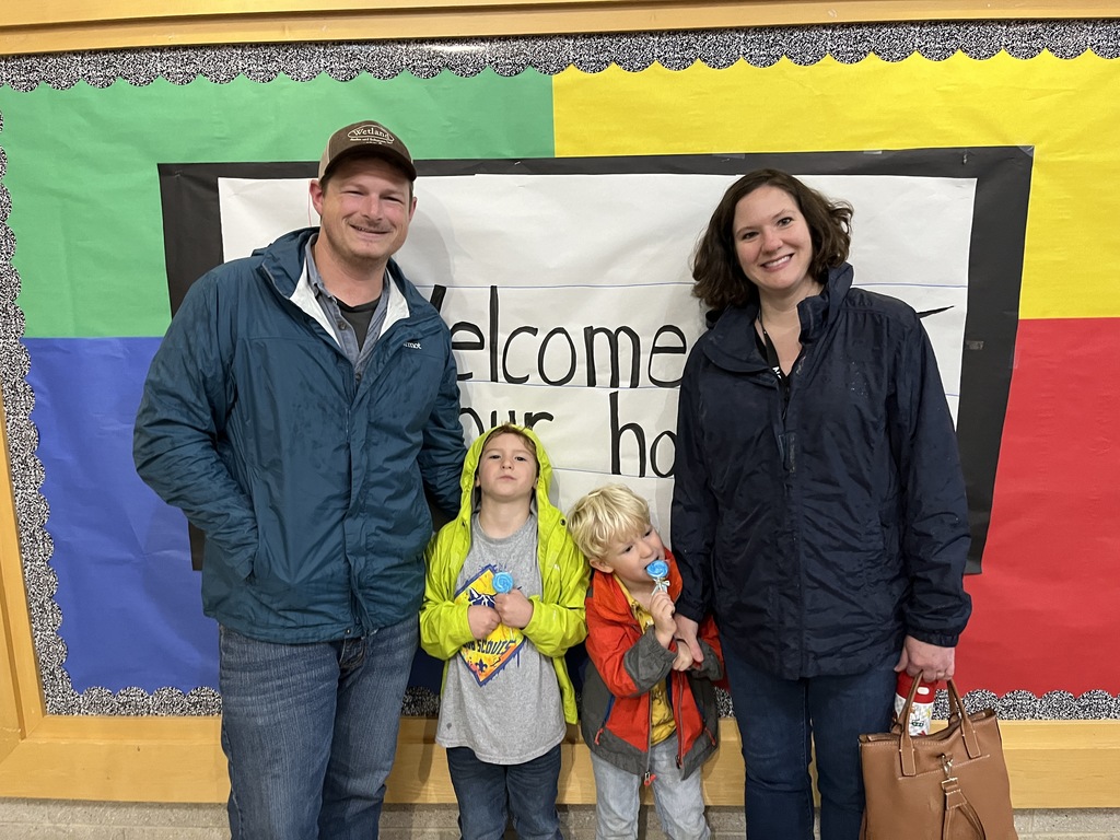 Two adults and two children pose for a photo.