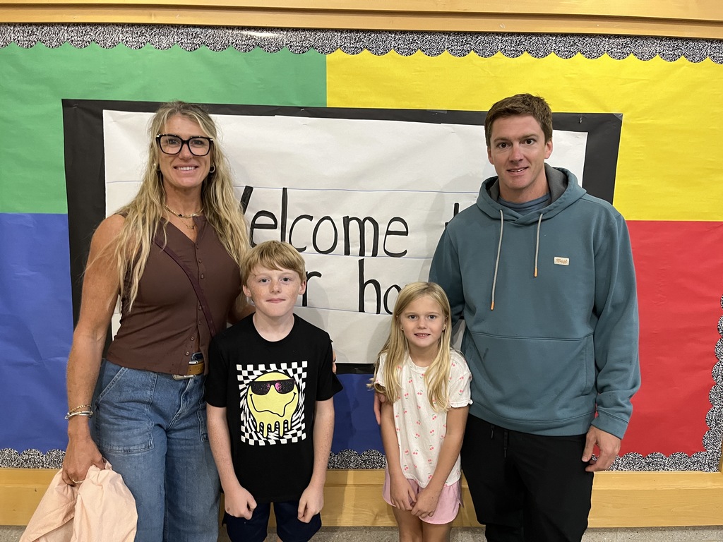 Two adults and two children pose for a photo.