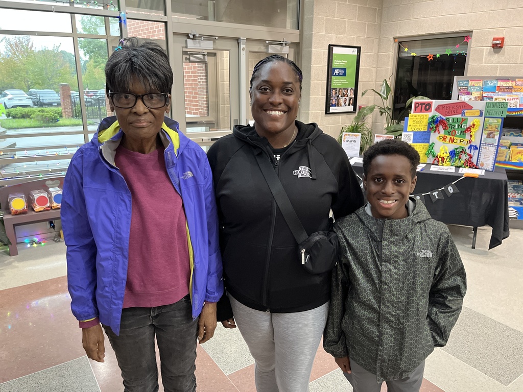 Two adults and a child  pose for a photo.