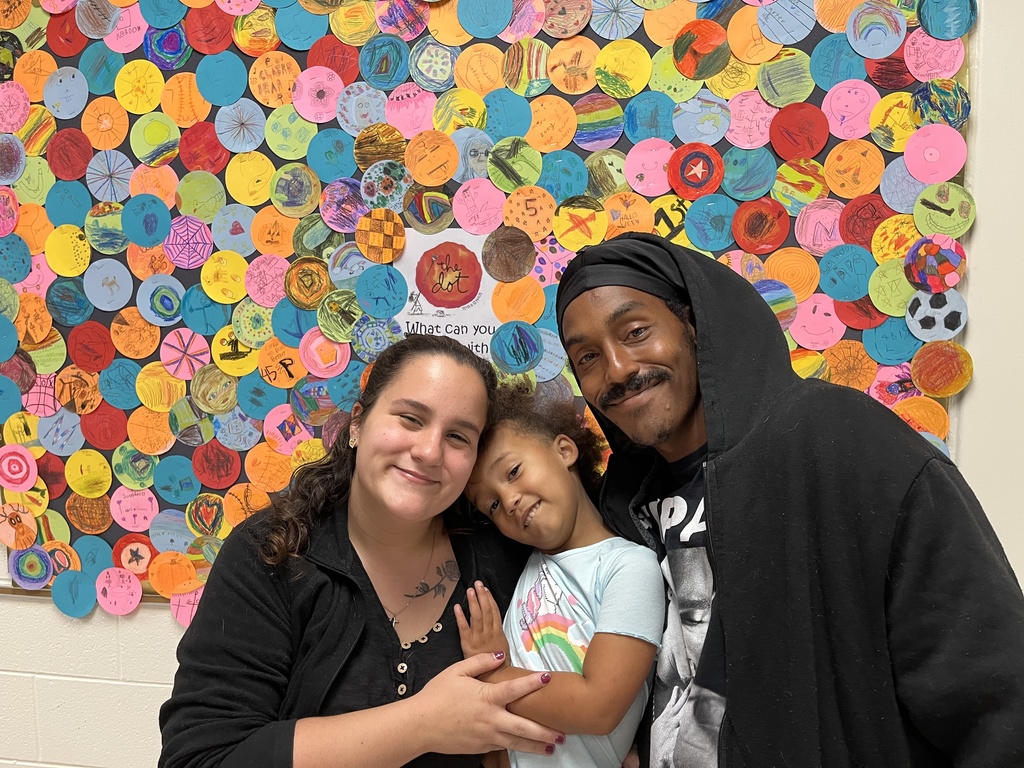 Two adults and a child pose for a photo.