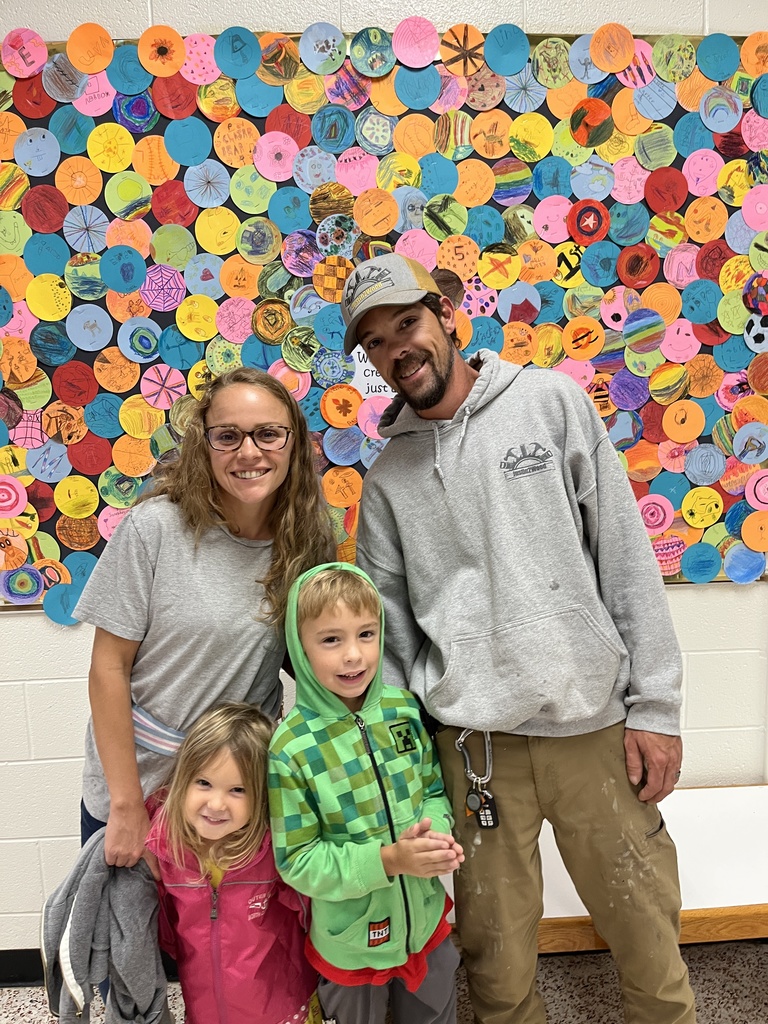 Two adults and two  children  pose for a photo.
