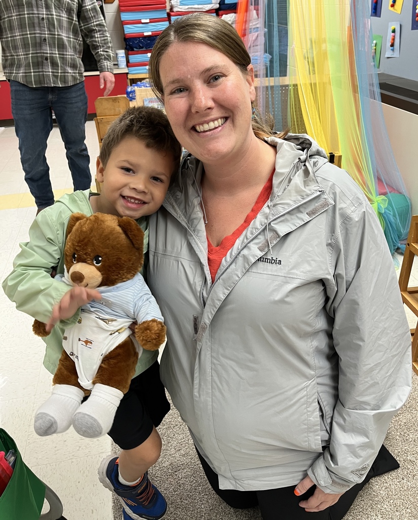 An adult and child pose for a photo.