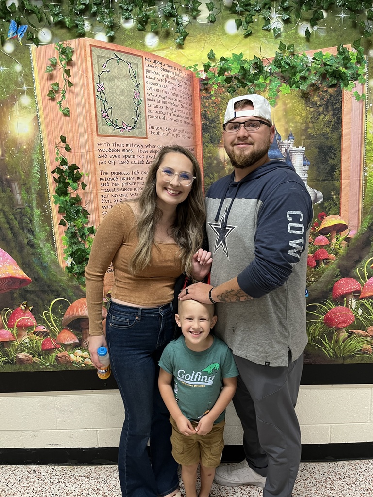 Two adults and a child pose for a photo.