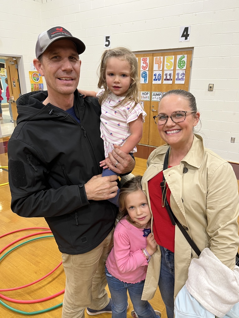 Two adults and two children pose for a photo. 