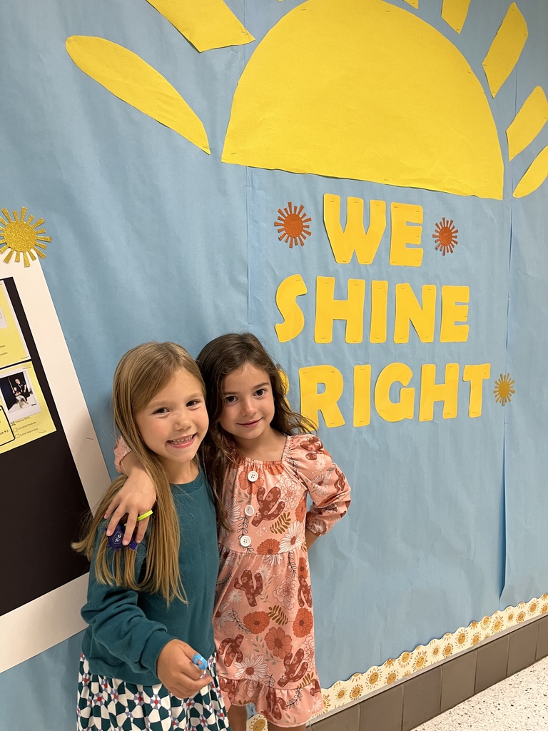 Two children pose for a photo. 