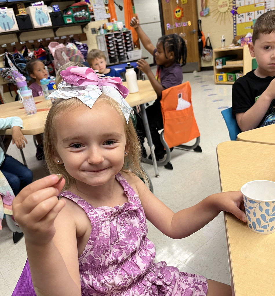 Preschoolers enjoy grapes as the snack for purple day.