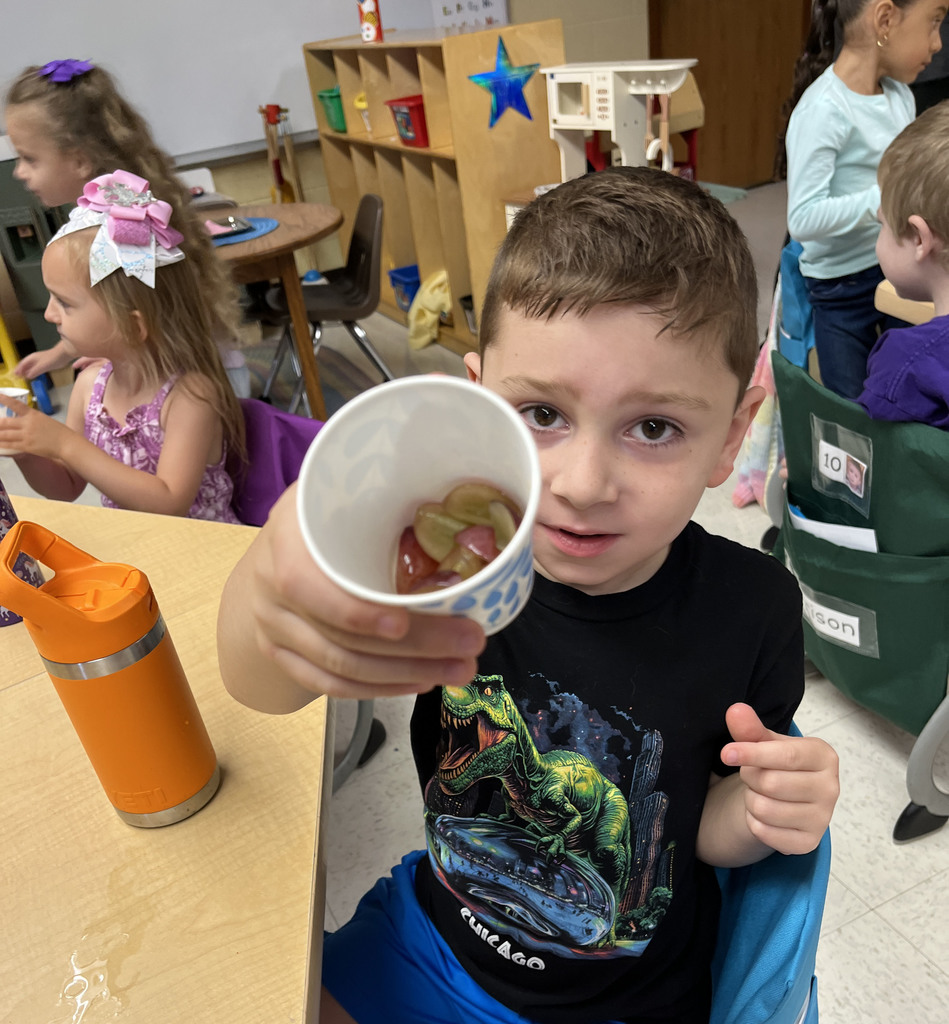 Preschoolers enjoy grapes as the snack for purple day.