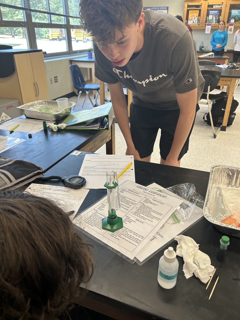 Students participate in a water experiment in biology class. 