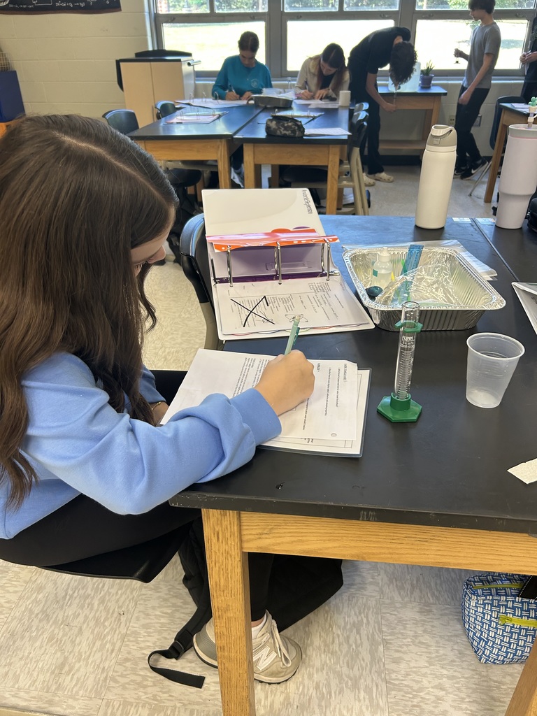 Students participate in a water experiment in biology class. 