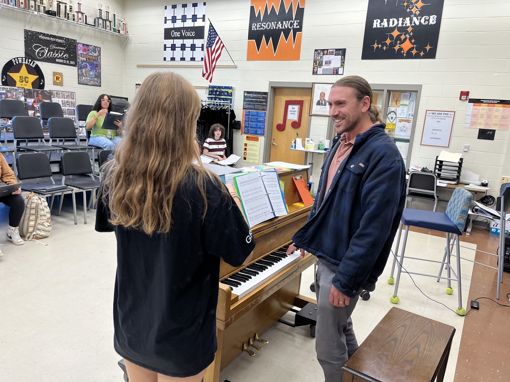 A student delivers a goodie bag to a teacher. 