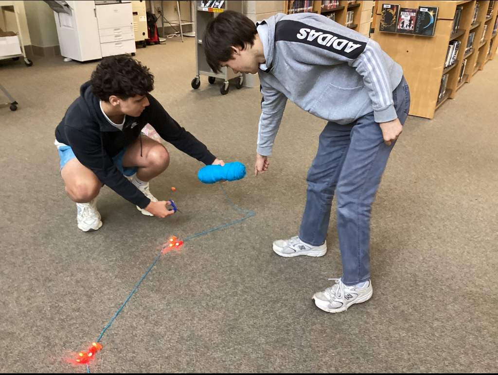Students in a library participate in a constellation station project.